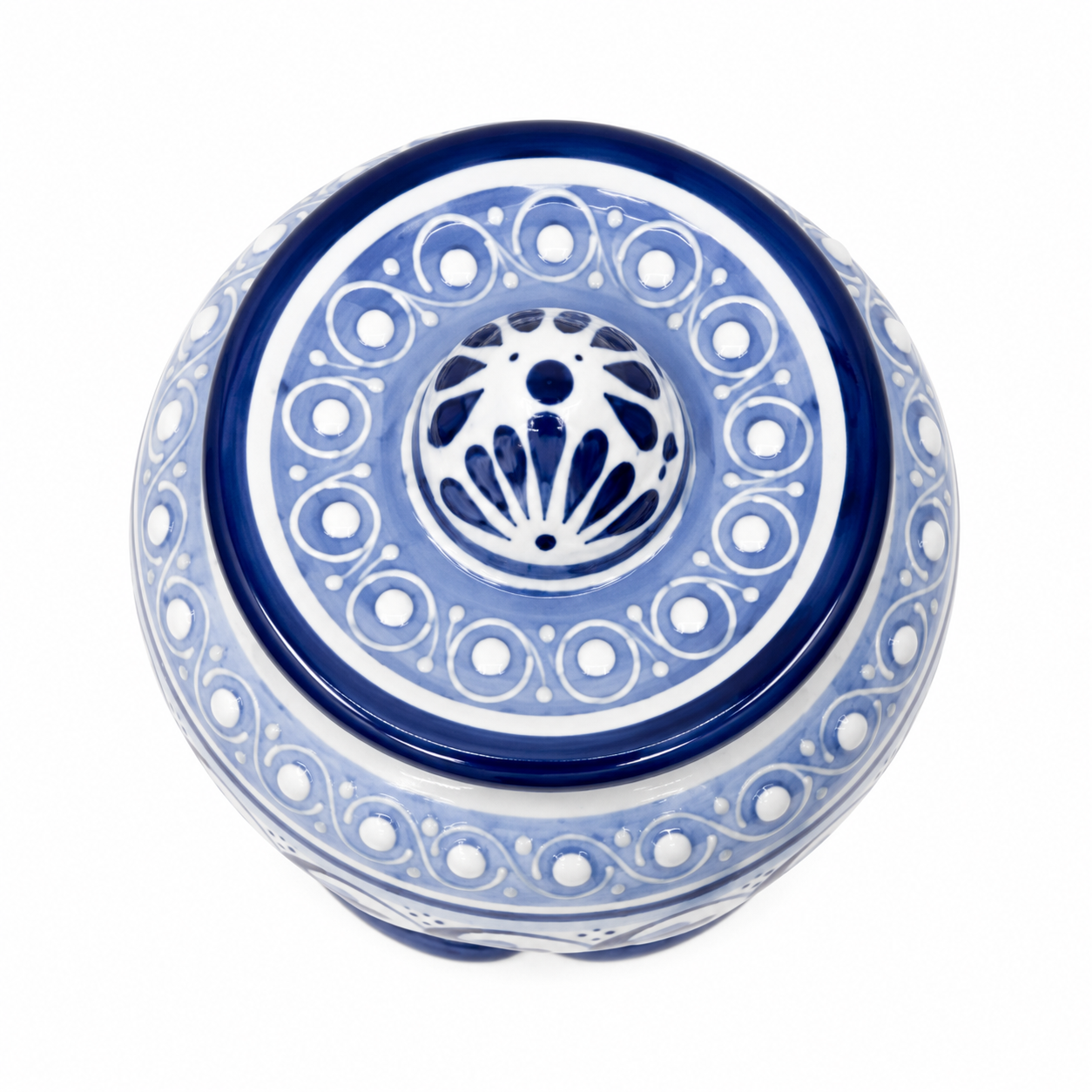 A round blue and white ceramic lidded container or box with intricate geometric and floral patterns, shown from a top-down view on a white background.