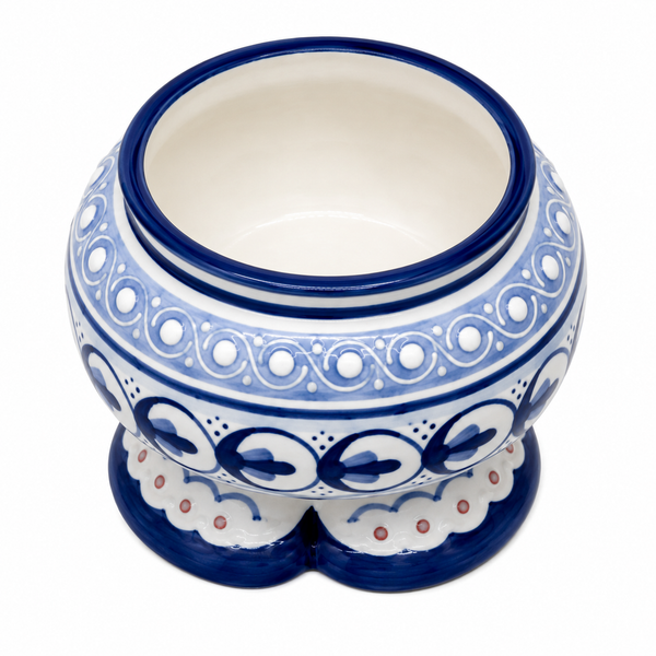 A round ceramic planter pot with a wide rim, featuring a blue and white hand-painted traditional pattern and a small double pedestal base, shown on a white background.