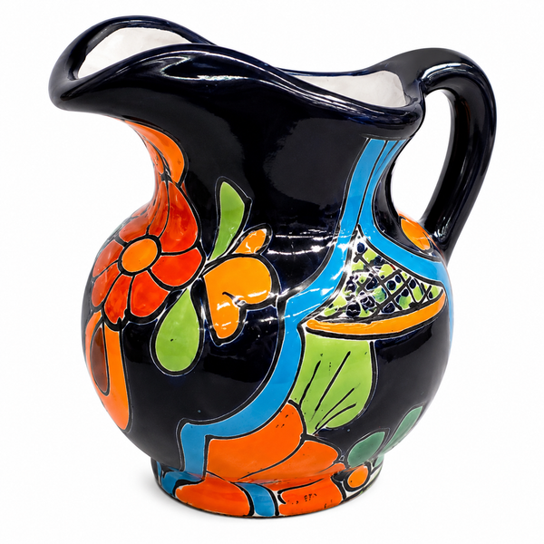 A glossy black ceramic pitcher decorated with vibrant hand-painted floral and leaf patterns in orange, green, and blue, set against a plain white background.