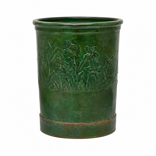 A green glazed ceramic planter with embossed floral details, shown against a plain white background.