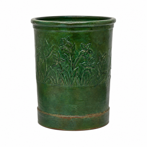 A green glazed ceramic planter with embossed floral details, shown against a plain white background.
