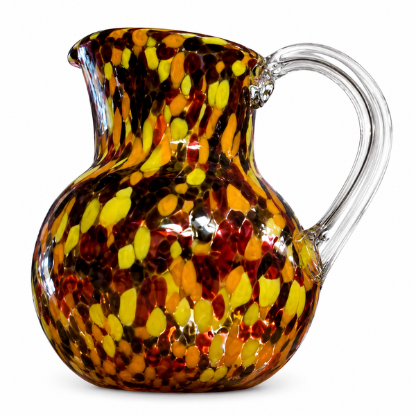 A decorative glass pitcher with a rounded body, flared rim, and curved handle, featuring a marbled pattern of yellow, orange, red, and dark brown glass on a white background.
