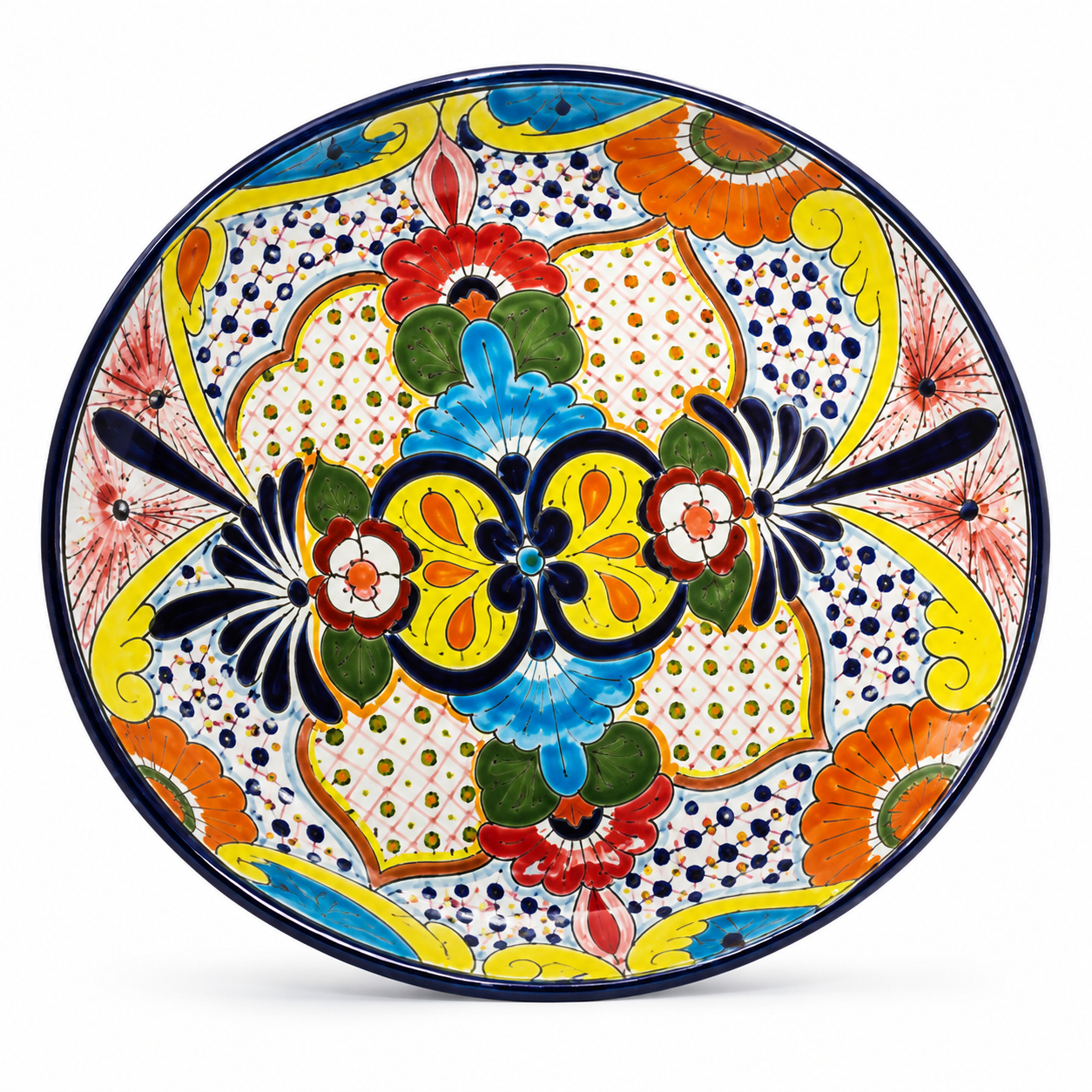 A round hand-painted ceramic plate with a vibrant, symmetrical Mediterranean style pattern featuring yellow, blue, orange, red, and green motifs on a white background.