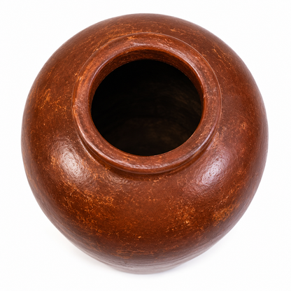 A round brown ceramic pot with a wide opening, shown from a top-down perspective on a white background.